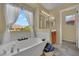 Spacious primary bathroom featuring a soaking tub with a large window and double sink vanity at 6187 Novelty St, Las Vegas, NV 89148