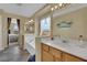 Primary bathroom featuring a soaking tub, double sinks, and large window with neighborhood views at 6187 Novelty St, Las Vegas, NV 89148