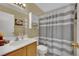 Bathroom with vanity and a shower with gray and white striped curtain at 6187 Novelty St, Las Vegas, NV 89148