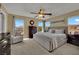 Neutral bedroom with multiple windows for natural light and a ceiling fan at 6187 Novelty St, Las Vegas, NV 89148