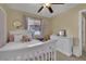 Neutral bedroom with light gray furniture, light pink accents, and a ceiling fan at 6187 Novelty St, Las Vegas, NV 89148