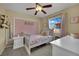 Bedroom featuring light gray furniture, light pink accents, and a ceiling fan at 6187 Novelty St, Las Vegas, NV 89148