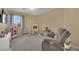 bedroom with a comfortable recliner, large window, and gray carpet at 6187 Novelty St, Las Vegas, NV 89148