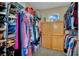Full closet with a window and rods and shelves for clothing and shoes at 6187 Novelty St, Las Vegas, NV 89148