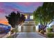 Charming home featuring a two-car garage, desert landscaping, and a picturesque sunset backdrop at 6187 Novelty St, Las Vegas, NV 89148