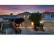 This two-story home boasts a well-maintained yard, mature trees, and a spacious driveway and attached two-car garage at 6187 Novelty St, Las Vegas, NV 89148