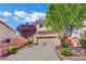 Attractive two-story home showcasing a two-car garage, driveway, and lush landscaping with mature trees at 6187 Novelty St, Las Vegas, NV 89148