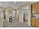 Hallway with neutral colored carpet, a table, and access to bedrooms and bathrooms at 6187 Novelty St, Las Vegas, NV 89148