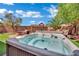 Relax and unwind in this backyard hot tub with a view of the lush landscaping at 6187 Novelty St, Las Vegas, NV 89148