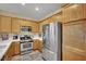 Well-equipped kitchen with stainless steel appliances and light wood cabinetry at 6187 Novelty St, Las Vegas, NV 89148