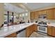 Bright kitchen featuring stainless steel appliances, tile countertops, and natural wood cabinets at 6187 Novelty St, Las Vegas, NV 89148