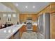 Full kitchen view with stainless appliances, tile countertops and oak cabinets at 6187 Novelty St, Las Vegas, NV 89148