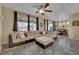 Comfortable living room with a large sectional sofa, ceiling fan, and backyard views at 6187 Novelty St, Las Vegas, NV 89148