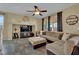 Relaxing living room featuring a sectional sofa, media center, and ceiling fan at 6187 Novelty St, Las Vegas, NV 89148