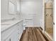 Bathroom featuring double sinks, quartz counters, and a walk-in shower at 6312 Conlon St, North Las Vegas, NV 89081