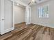 Bright bedroom with wood floors, ceiling fan, and natural light from the window at 6312 Conlon St, North Las Vegas, NV 89081