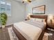 This bedroom boasts hardwood floors, a ceiling fan, and a large window with wooden blinds at 6312 Conlon St, North Las Vegas, NV 89081
