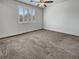Neutral bedroom with a ceiling fan, plantation shutters, and soft carpet flooring at 6312 Conlon St, North Las Vegas, NV 89081