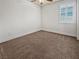 Neutral bedroom with a ceiling fan, plantation shutters, and soft carpet flooring at 6312 Conlon St, North Las Vegas, NV 89081