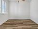 A bright bedroom featuring wood floors and a window with plantation shutters at 6312 Conlon St, North Las Vegas, NV 89081