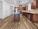 Modern kitchen featuring stainless steel appliances, granite countertops, and wood floors at 6312 Conlon St, North Las Vegas, NV 89081