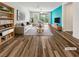 Bright, virtually staged living room with contemporary furniture, wood floors, and a vivid accent wall at 6312 Conlon St, North Las Vegas, NV 89081