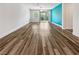 Bright and airy living room showcasing wood floors, neutral walls, and a sliding glass door to the backyard at 6312 Conlon St, North Las Vegas, NV 89081