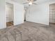 Main bedroom with ceiling fan, neutral carpet, and access to the walk-in closet and bathroom at 6312 Conlon St, North Las Vegas, NV 89081