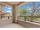 Balcony with wrought iron railings and views of trees and neighborhood at 664 Peachy Canyon Cir # 103, Las Vegas, NV 89144