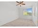 Cozy bedroom with carpet, ceiling fan, and a window with views of the outdoors at 664 Peachy Canyon Cir # 103, Las Vegas, NV 89144