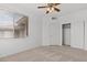 Bright bedroom with a ceiling fan, closet, window, and neutral carpet at 664 Peachy Canyon Cir # 103, Las Vegas, NV 89144