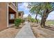Exterior view of the home with mature landscaping at 664 Peachy Canyon Cir # 103, Las Vegas, NV 89144