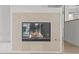 Close up of a fireplace with decorative tiling and a black metal screen at 664 Peachy Canyon Cir # 103, Las Vegas, NV 89144
