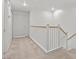 Upstairs hallway featuring carpet, white walls and doors, and wood railings at 664 Peachy Canyon Cir # 103, Las Vegas, NV 89144