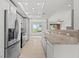 Kitchen with stainless steel appliances, tiled counter and a view into an adjoining living space at 664 Peachy Canyon Cir # 103, Las Vegas, NV 89144