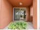 The covered patio looks out onto the lush landscaping at 664 Peachy Canyon Cir # 103, Las Vegas, NV 89144