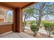 Covered patio looking at the verdant landscaping and golf course at 664 Peachy Canyon Cir # 103, Las Vegas, NV 89144