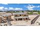 New construction home showing wood framing and a detached garage in a desert setting with city views at 7118 Painted Skyline St, Las Vegas, NV 89118