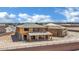Framed new construction home featuring a detached garage with desert landscape and blue sky at 7118 Painted Skyline St, Las Vegas, NV 89118