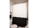 The full bathroom showcases a shower/tub with a stylish two-toned shower curtain at 7411 Sunray Point St, North Las Vegas, NV 89084