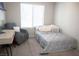 Bright bedroom with a comfortable single bed, desk and an armchair at 7411 Sunray Point St, North Las Vegas, NV 89084
