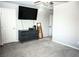 This bedroom offers a large TV, lots of space and carpeted floors at 7411 Sunray Point St, North Las Vegas, NV 89084