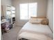 Cozy bedroom with a daybed, decorative pillows and shelving for storage at 7411 Sunray Point St, North Las Vegas, NV 89084