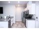 Well-lit kitchen featuring granite countertops, stainless steel appliances, and white cabinetry at 7411 Sunray Point St, North Las Vegas, NV 89084