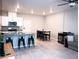 Open-concept kitchen and living area featuring modern finishes, stainless steel appliances, and laminate wood flooring at 7411 Sunray Point St, North Las Vegas, NV 89084