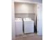 Convenient laundry area with new washer and dryer units, storage shelf and tile floors at 7411 Sunray Point St, North Las Vegas, NV 89084
