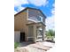 Side view of a two-story home with desert landscaping featuring a covered porch entry at 7411 Sunray Point St, North Las Vegas, NV 89084
