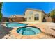 Backyard oasis with pool, spa, and neutral colored stucco home exterior at 7521 Reindeer Ct, Las Vegas, NV 89147