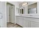 Bathroom features double sinks, quartz counters, updated cabinets, and walk-in shower at 7521 Reindeer Ct, Las Vegas, NV 89147