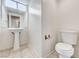 Bathroom featuring a pedestal sink and toilet at 7521 Reindeer Ct, Las Vegas, NV 89147